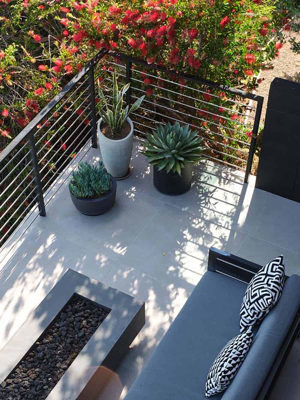 modern rooftop deck with lounge chair potted agave snake plant and red bottlebrush flowers San Francisco Bay hillside home