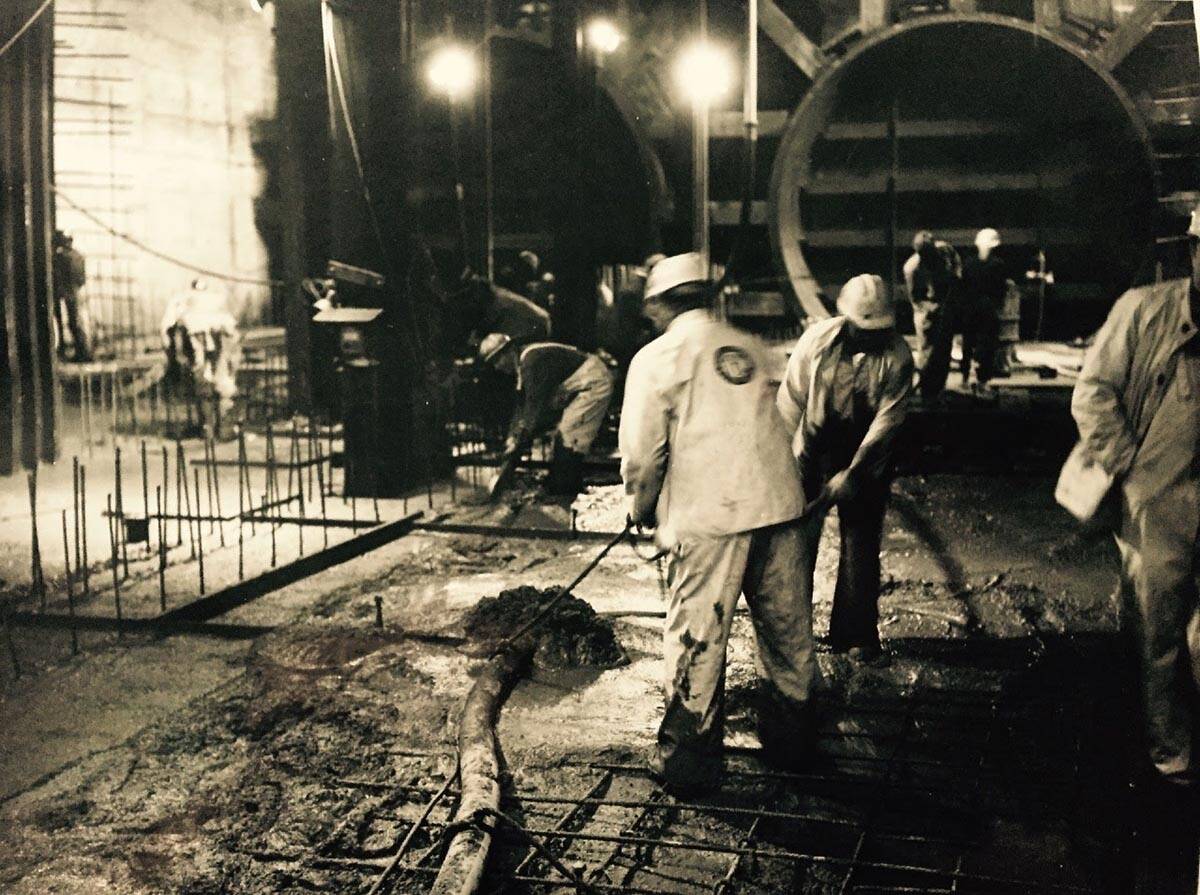 vintage black and white photo of construction workers pouring concrete framed art in midcentury modern Bay Heirloom home