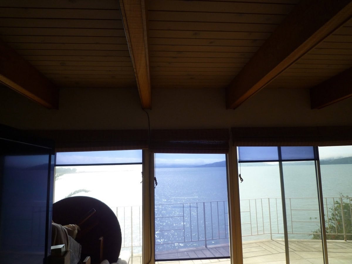 before renovation, mid-century modern open-plan living and dining room in Point Richmond, California, with views of the San Francisco Bay