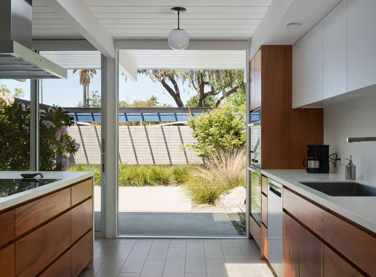 Eichler kitchen with sliding glass door open to drought tolerant garden courtyard Sunnyvale California Klopf Architecture