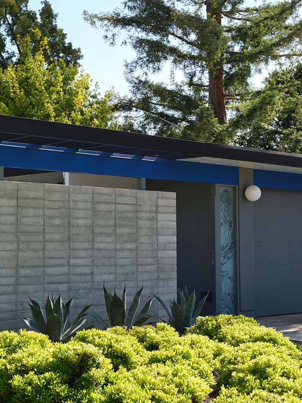 mid-century modern Eichler home front exterior with blue steel pergola concrete block wall agave plants and globe light