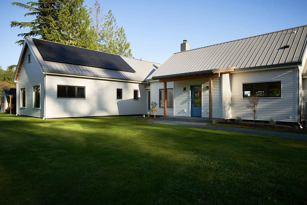 Northeast corner of the NorthShore Residence with natural landscaping and Pacific Northwest forest backdrop