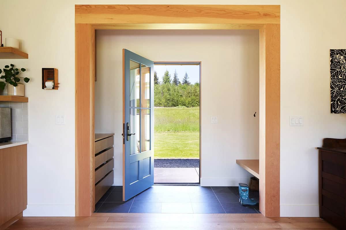 Interior view of the front entry foyer at the NorthShore Residence with natural light and warm material palette