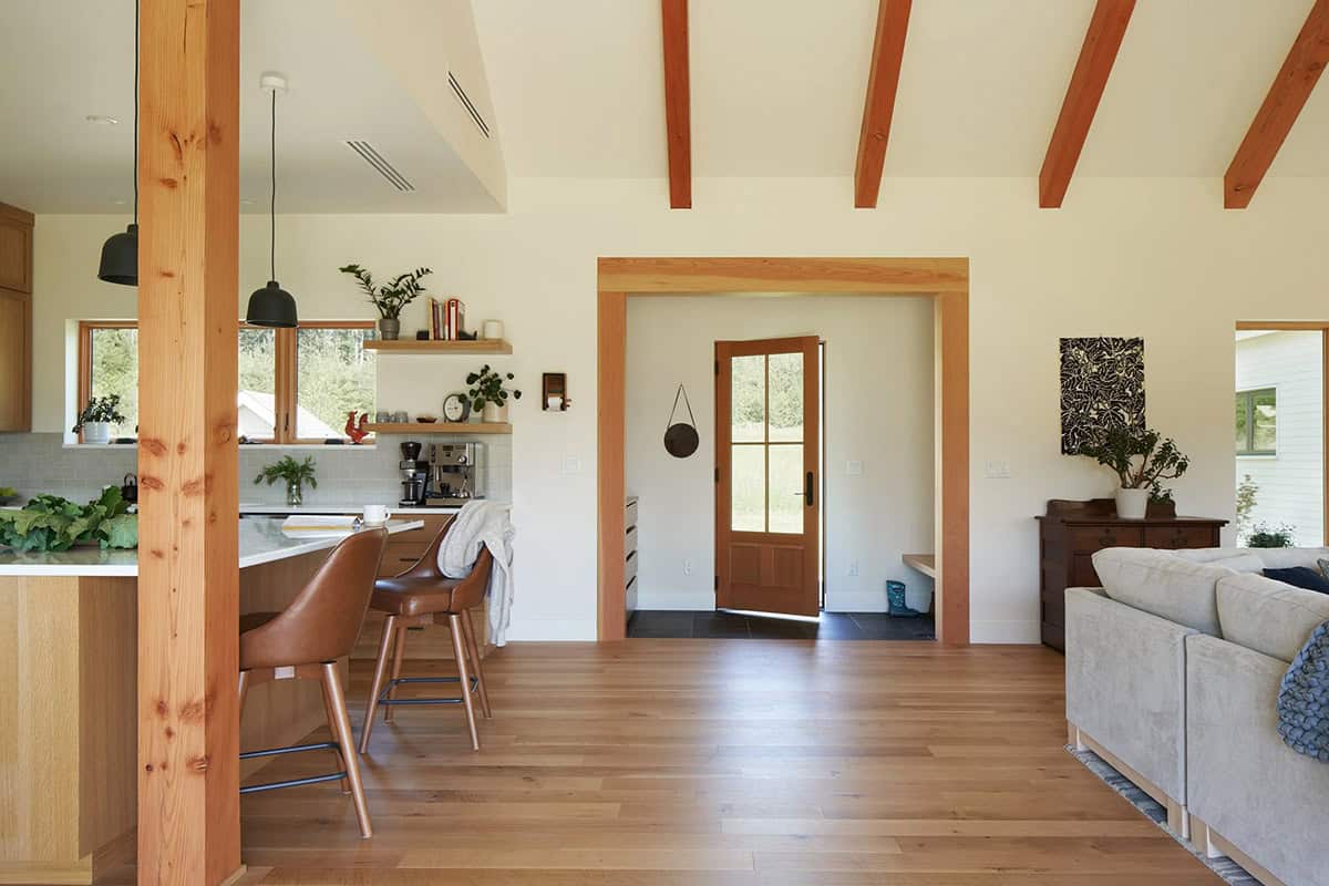 Looking inward from the front door of the NorthShore Residence, revealing the open and light-filled interior beyond the entry