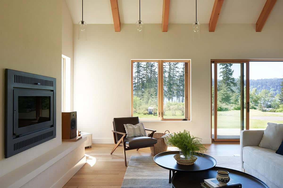 Accent chair and warm interior finishes in the NorthShore Residence living room, designed by Spiral Design Studios