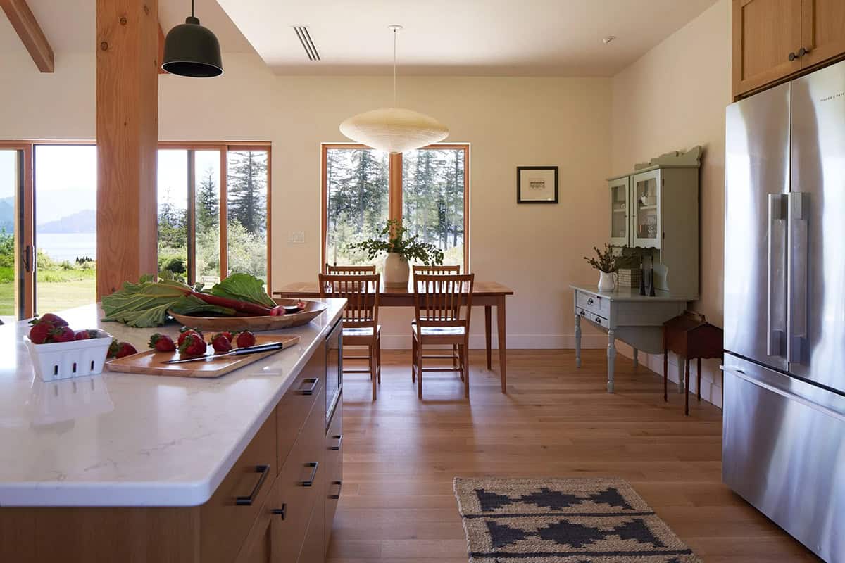 View from the NorthShore Residence kitchen into the dining room, demonstrating the home's seamless open-plan flow