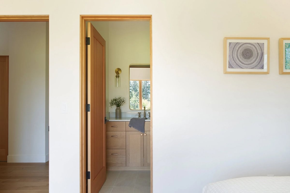 Primary bathroom at the NorthShore Residence with warm natural materials and spa-like design by Spiral Design Studios
