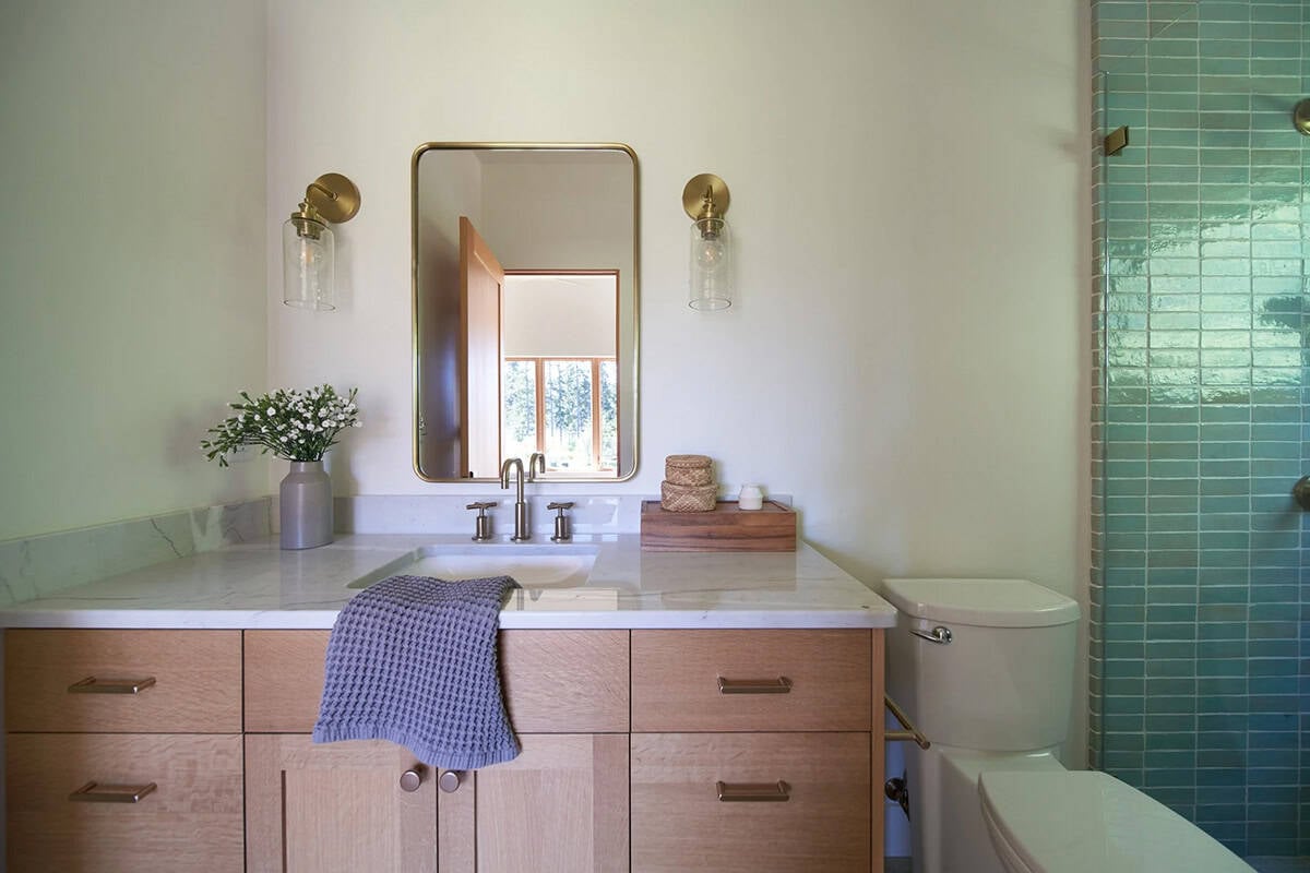 Second angle of the NorthShore Residence primary bathroom showing dual vanity layout and refined fixtures