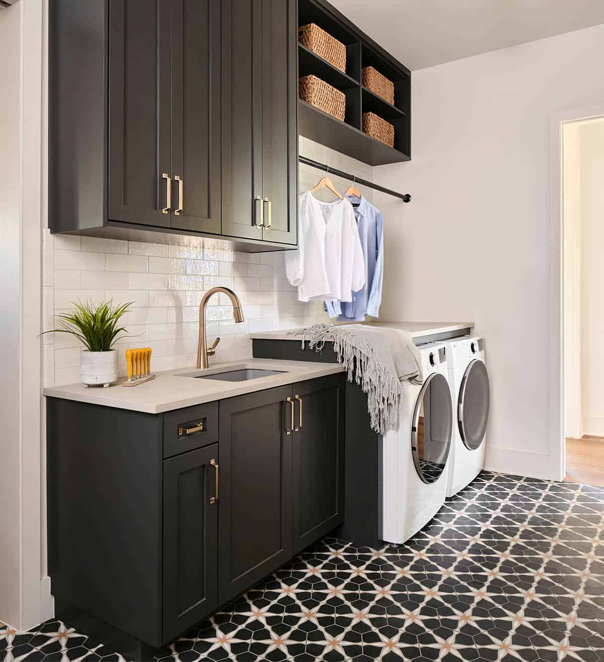 modern laundry room with dark cabinets