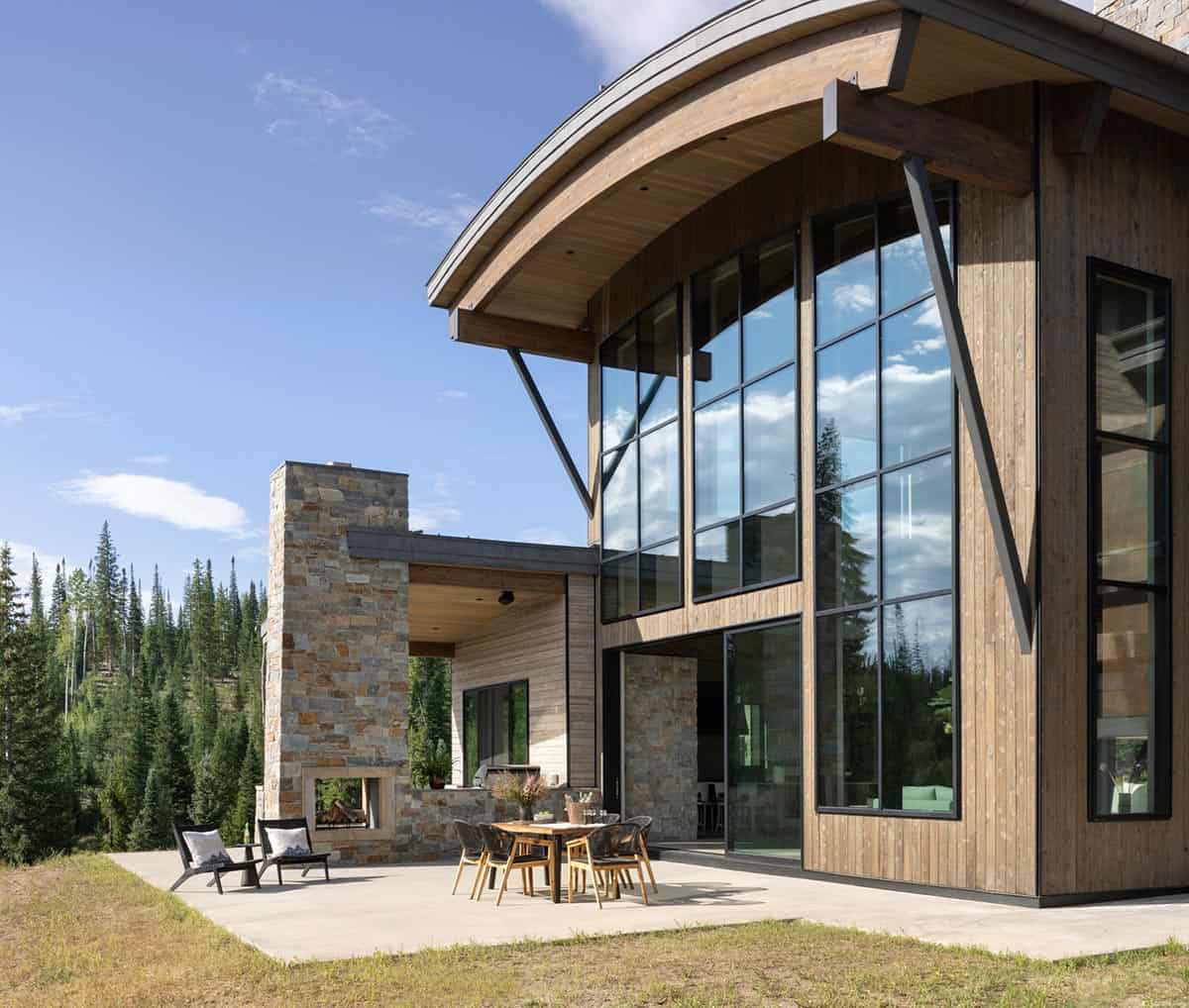 mountain contemporary home exterior with a patio and fireplace