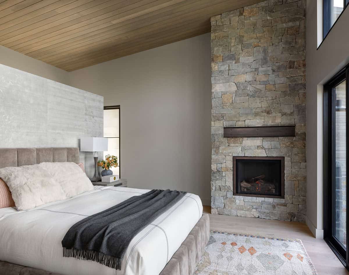 contemporary bedroom with a fireplace