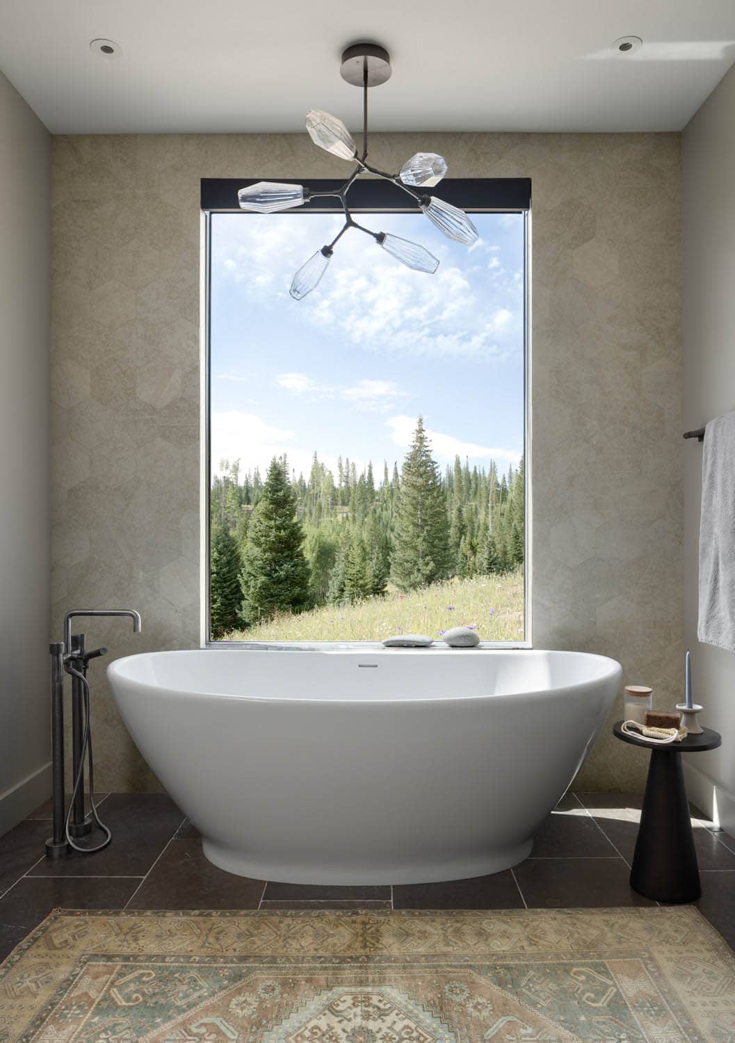 contemporary bathroom with a freestanding tub and large window