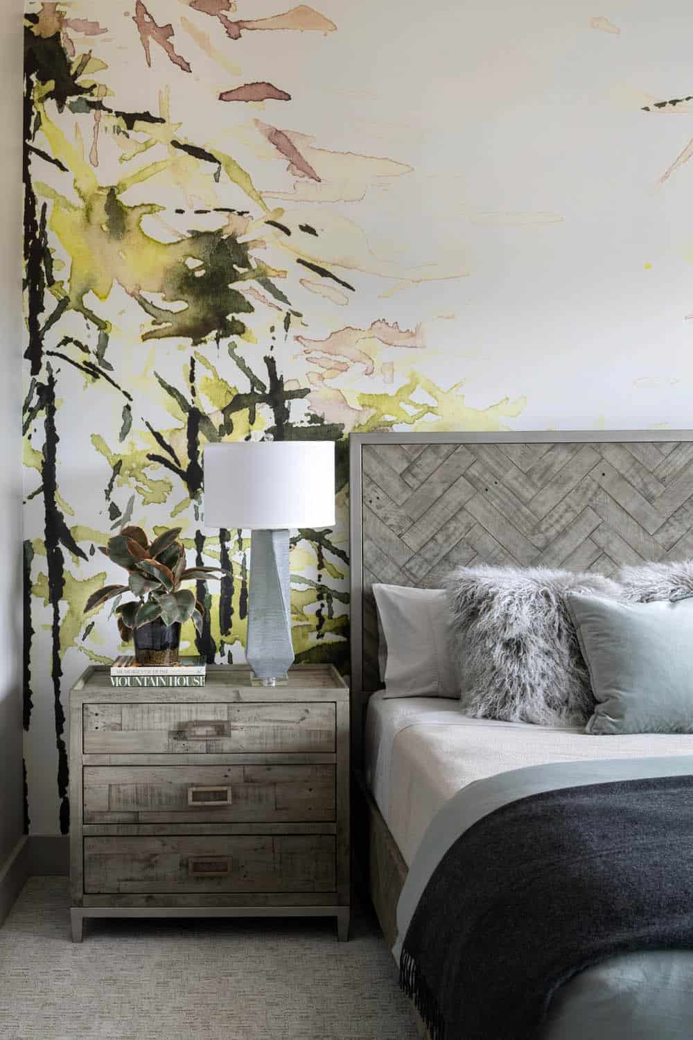 contemporary bedroom with accent wallpaper behind the headboard