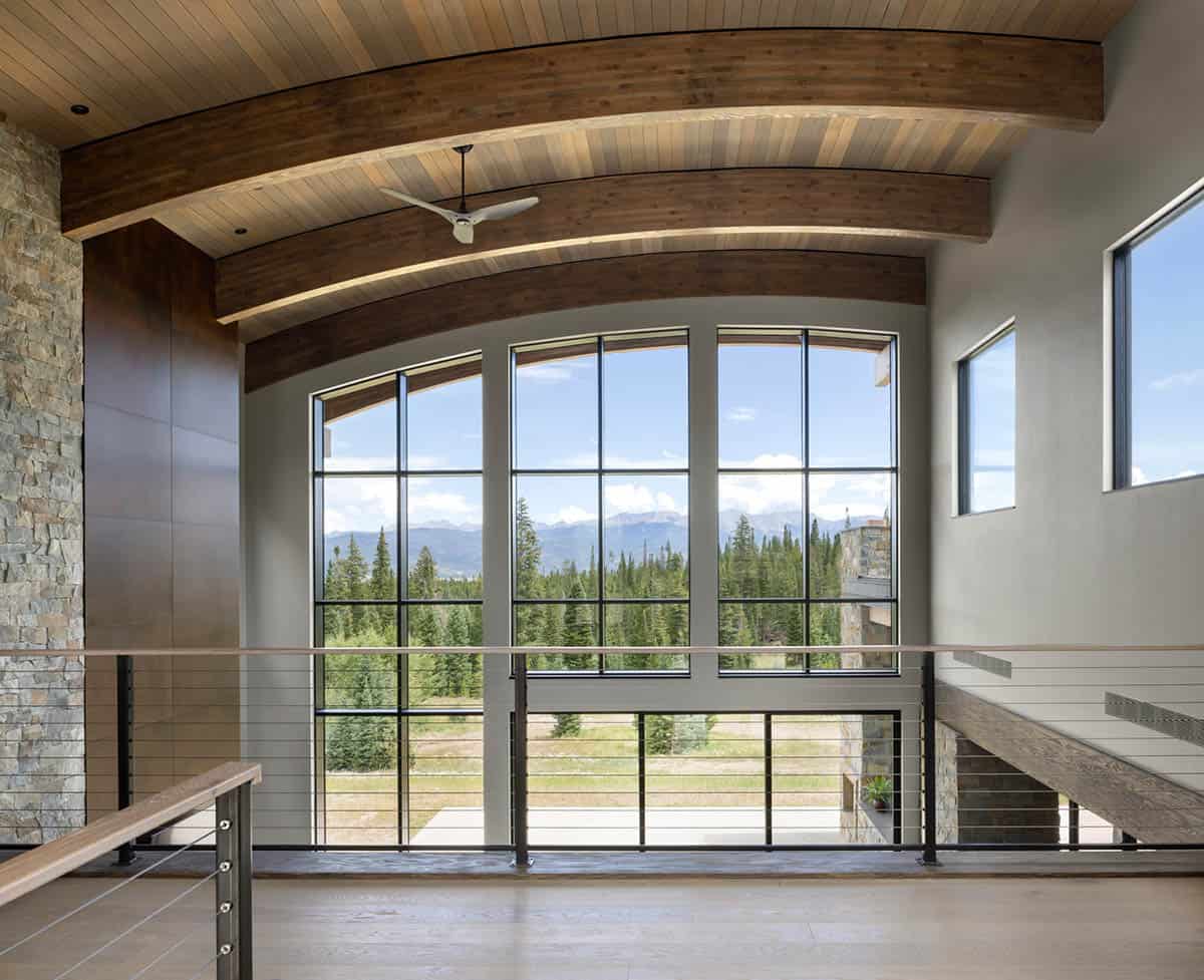 contemporary upstairs hallway with a curved ceiling and large windows