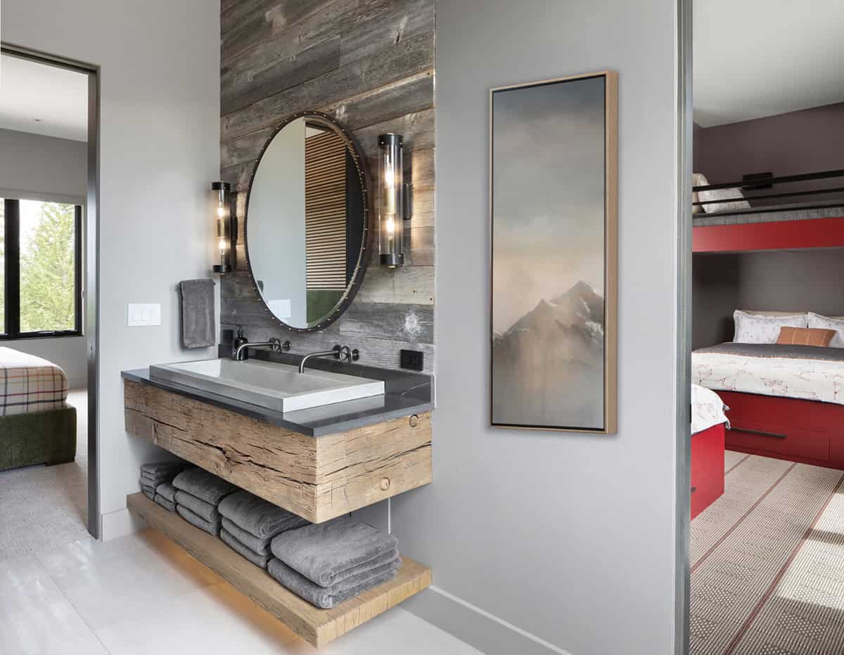 contemporary bathroom vanity with a round mirror and functional storage