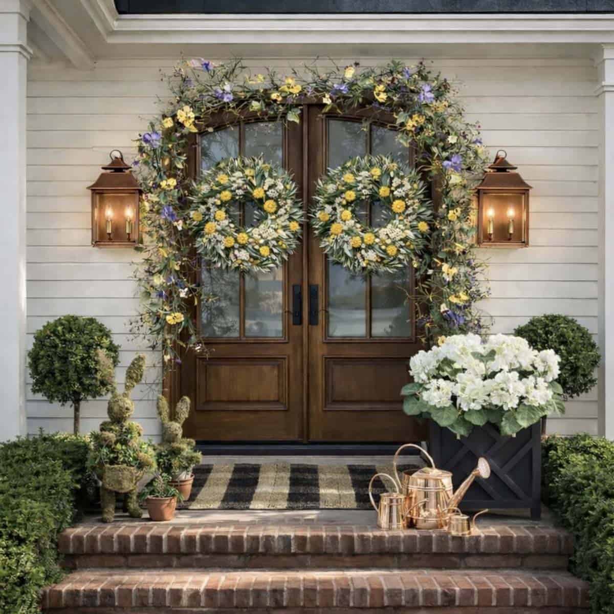 spring front porch with garland, wreaths and bunnies