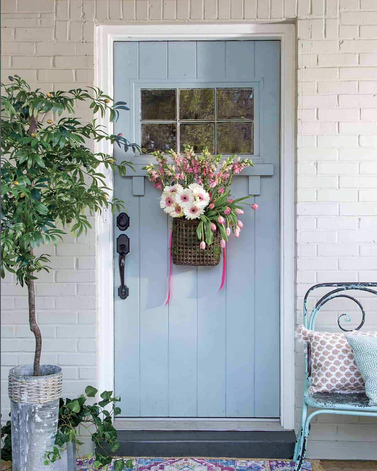 blue front door with a hanging basket