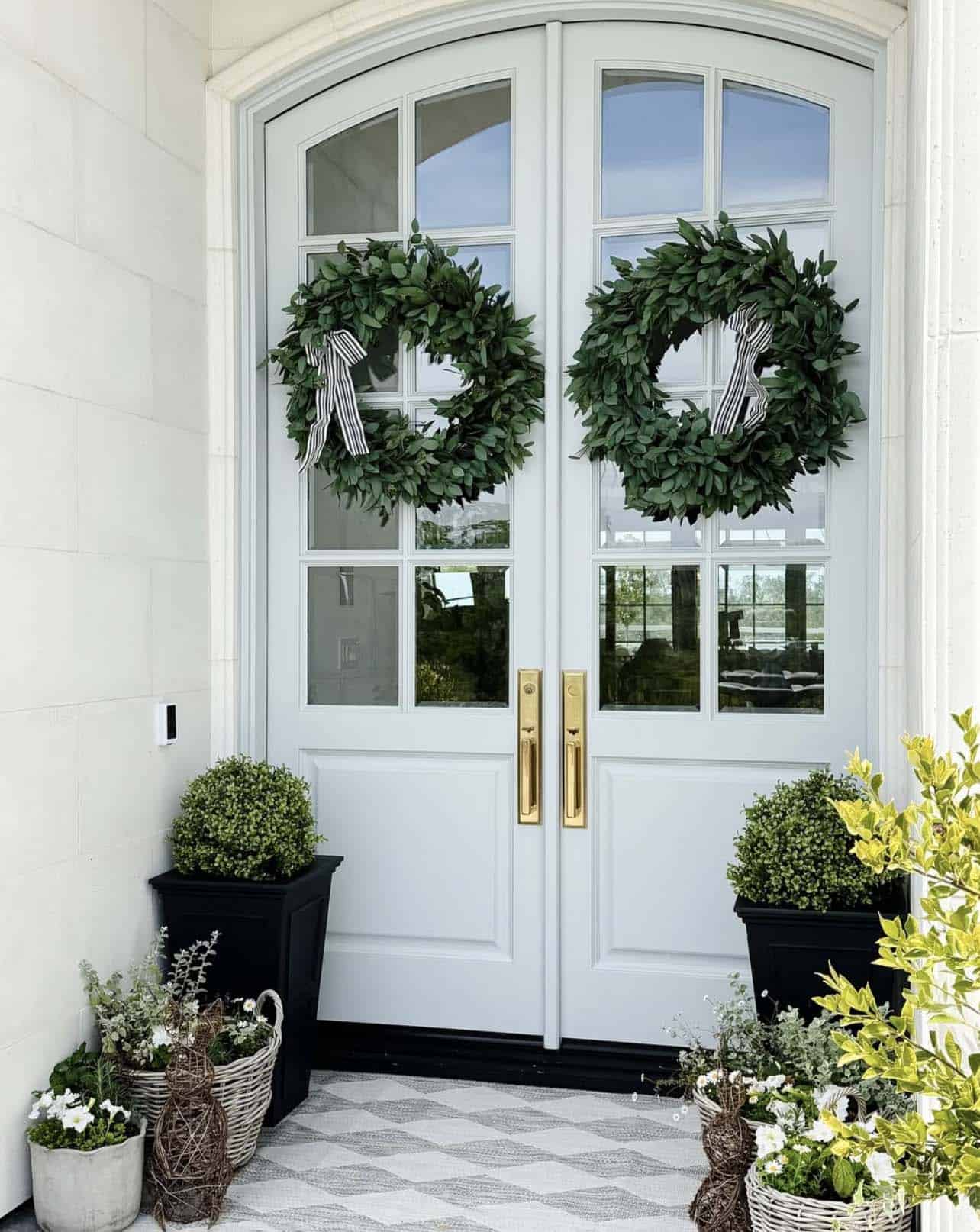 spring decorated front porch with wreaths