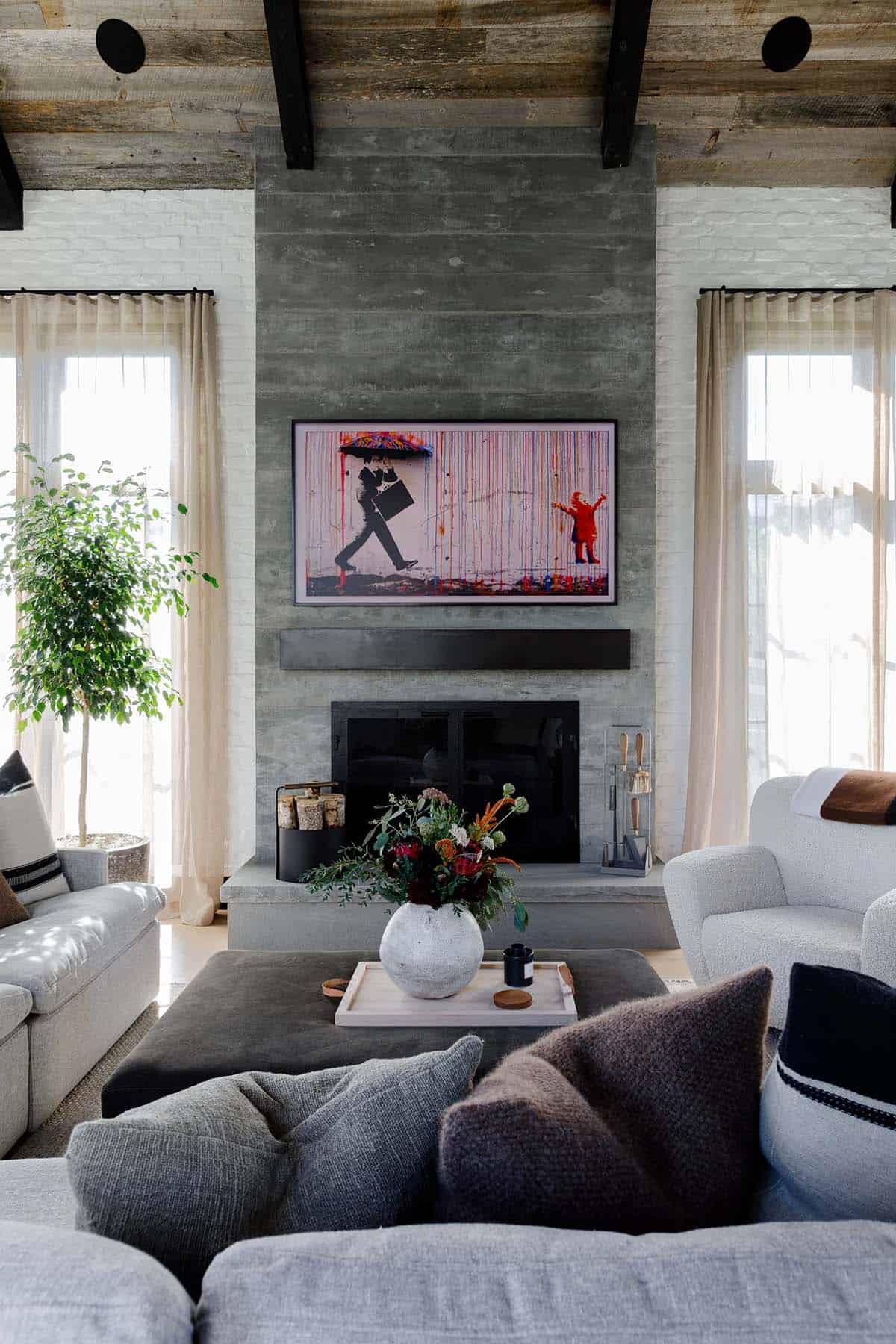 rustic modern living room with a fireplace and artwork