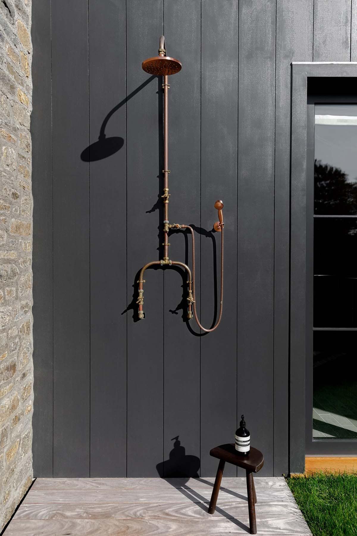 rustic modern barn house exterior with an outdoor shower off the pool