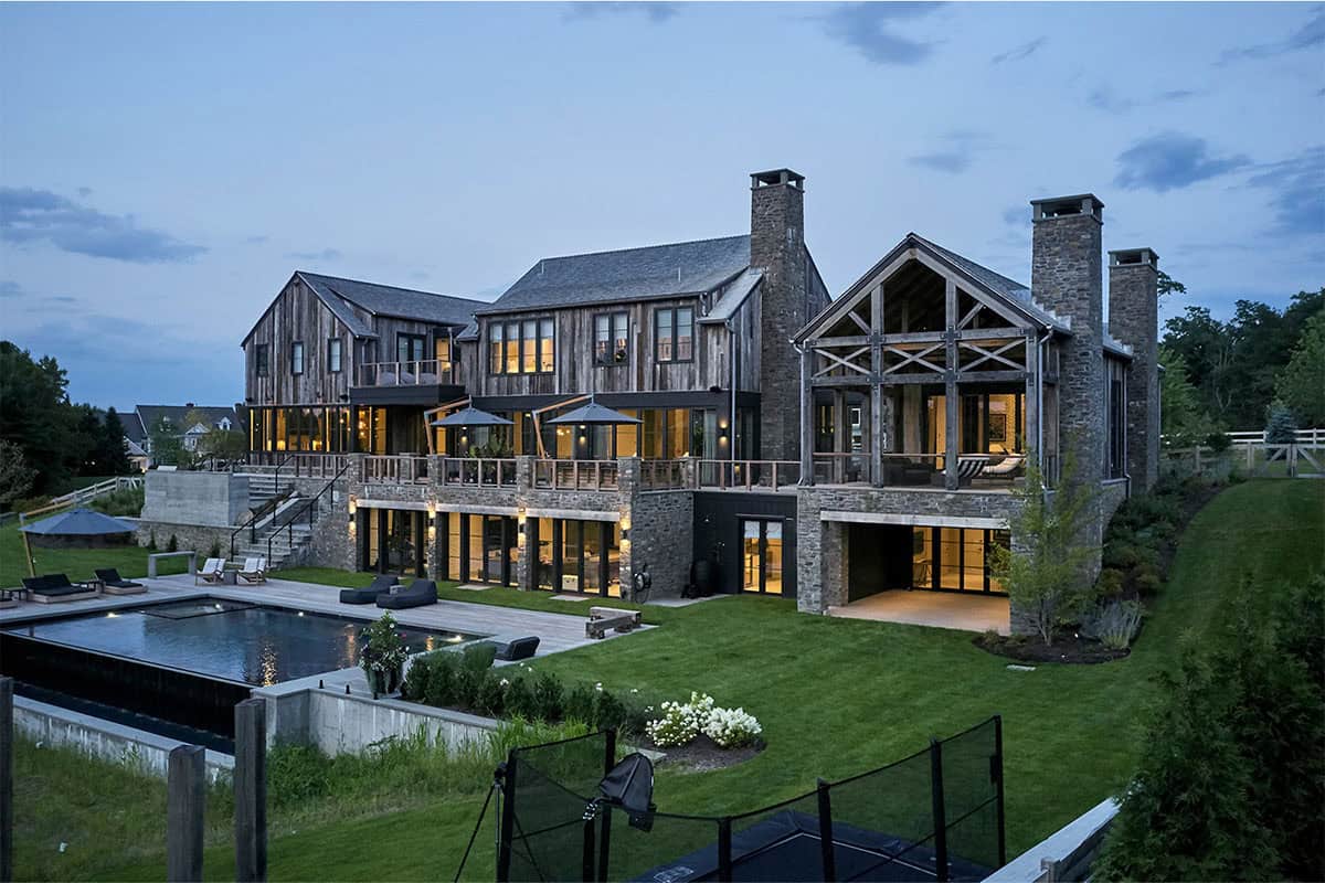 rustic modern barn house exterior backyard view at dusk