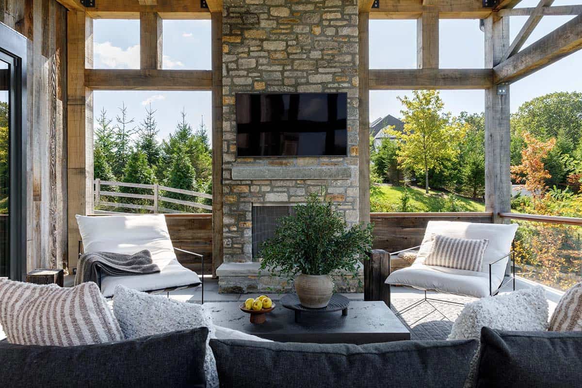 rustic modern covered porch with a fireplace