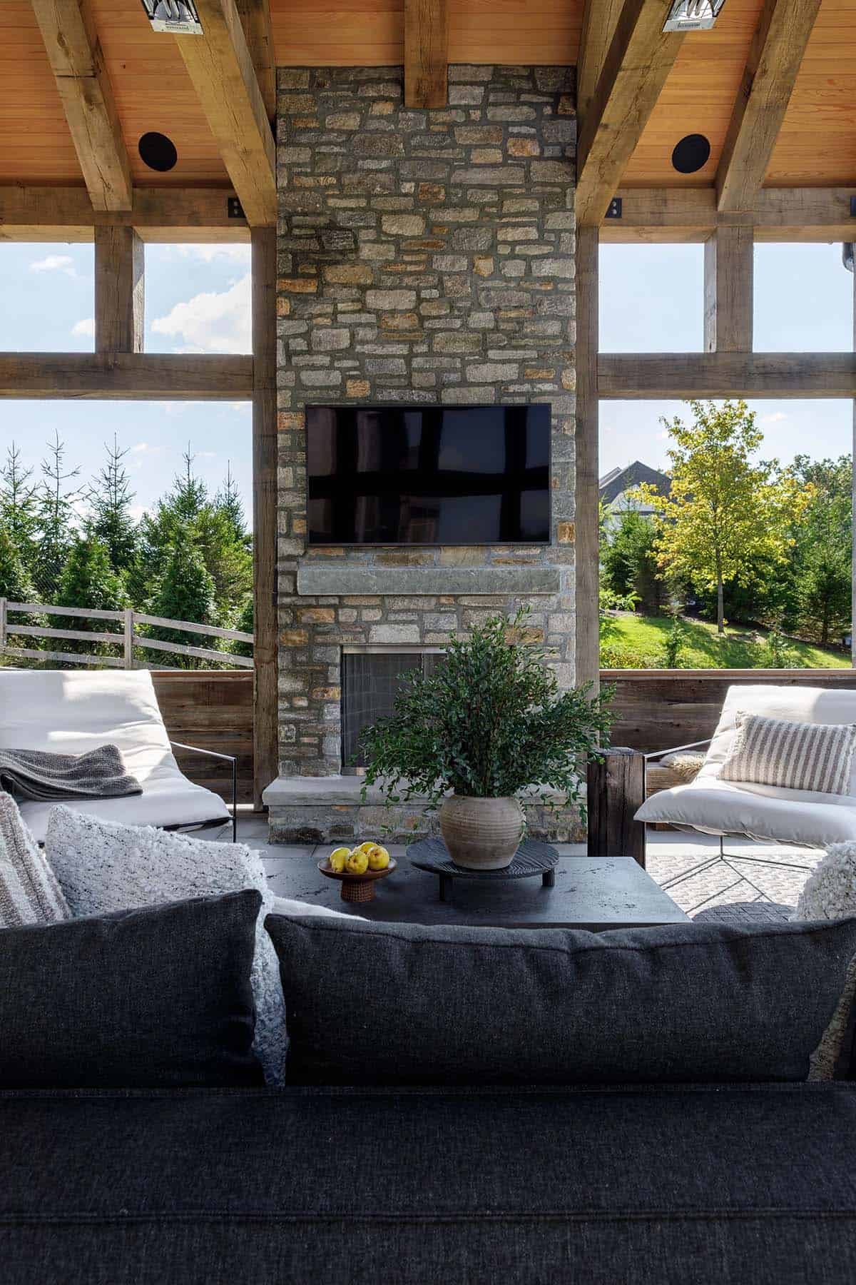 rustic modern covered porch with a fireplace