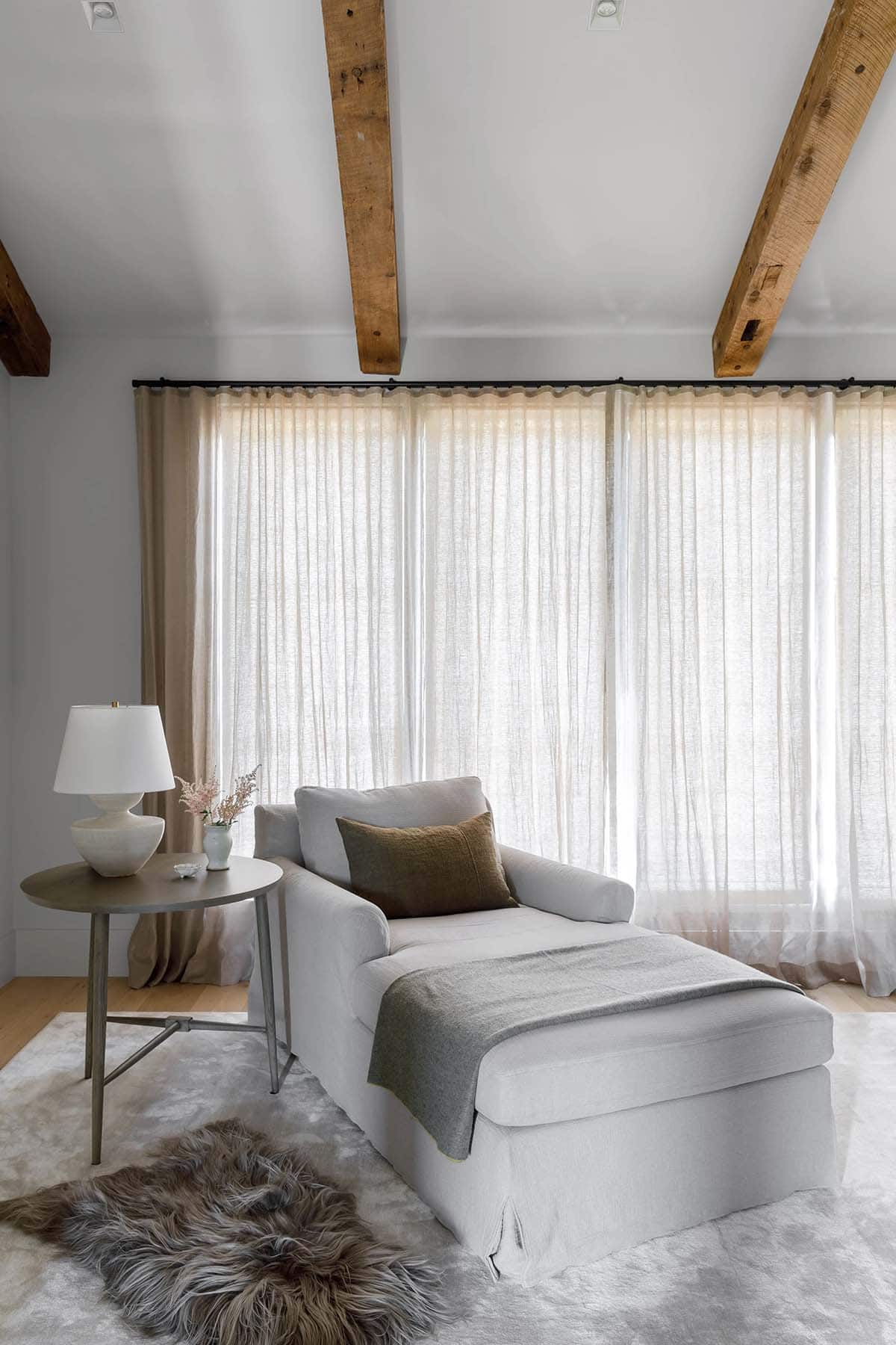 rustic modern bedroom with a chaise lounge