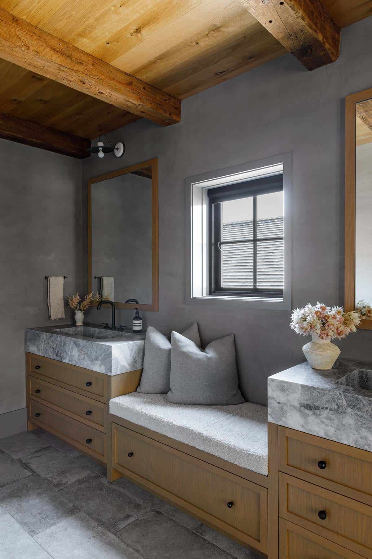rustic modern bathroom with vanities and built-in window seat