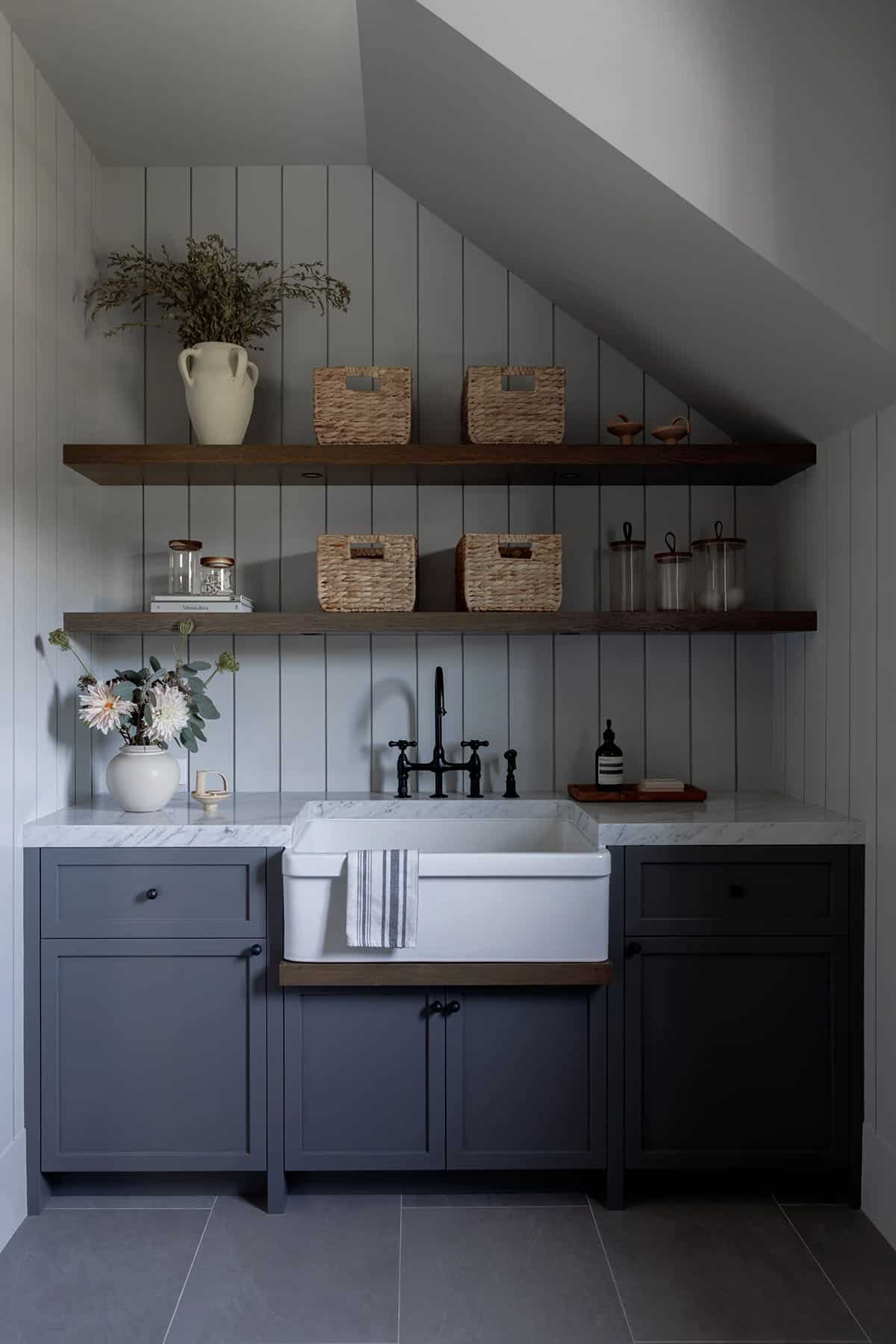rustic modern laundry room with a sink and floating shelves