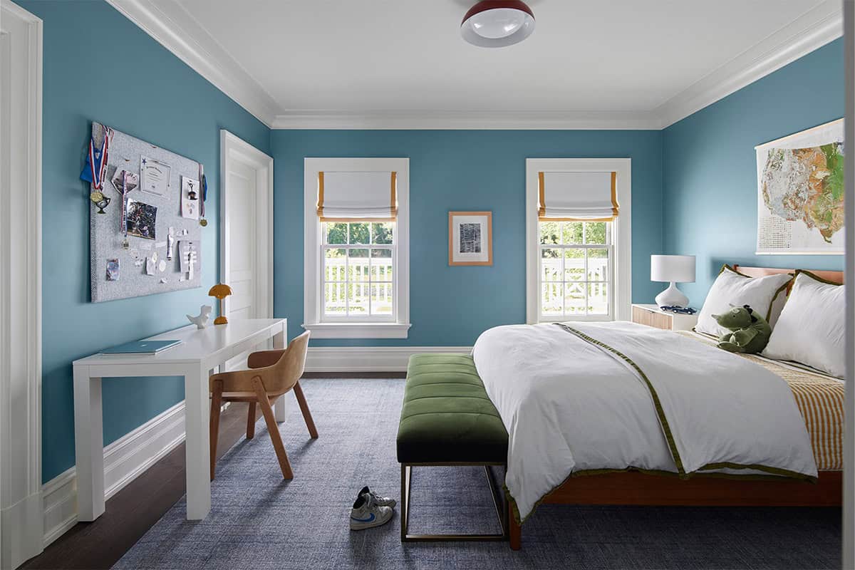 transitional style bedroom with blue walls