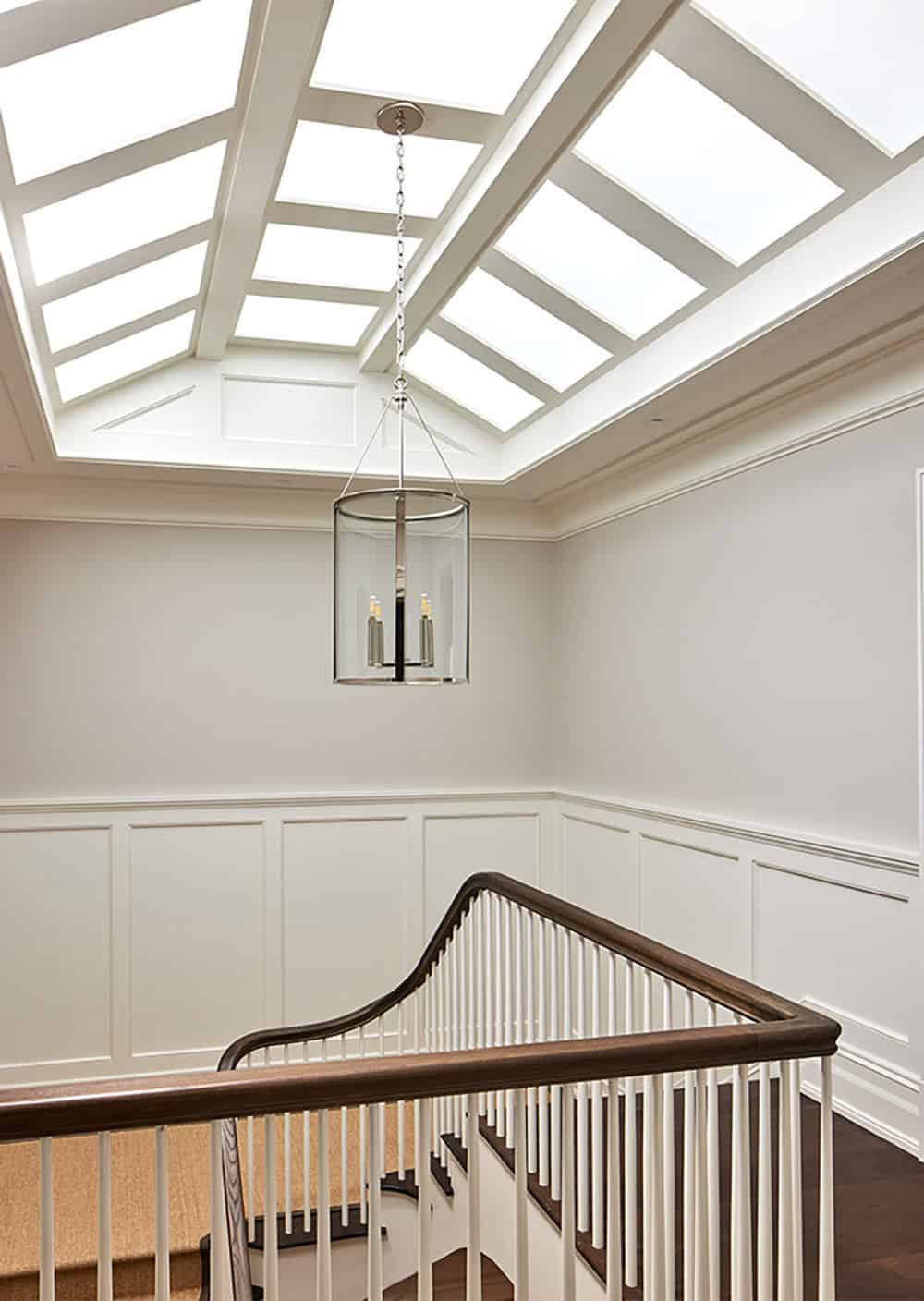 transitional style staircase with a skylight