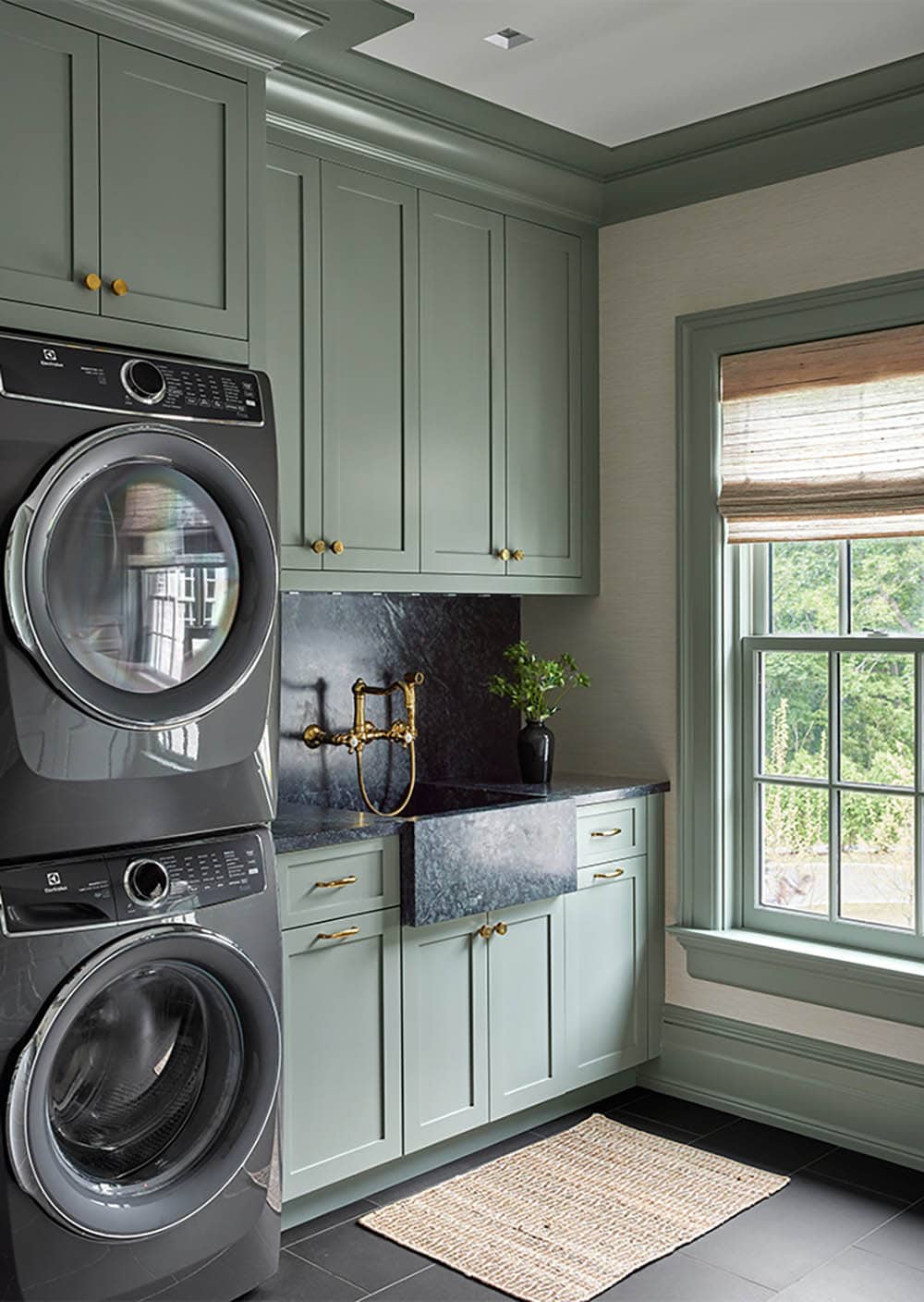 transitional style laundry room with stackable washer and dryer