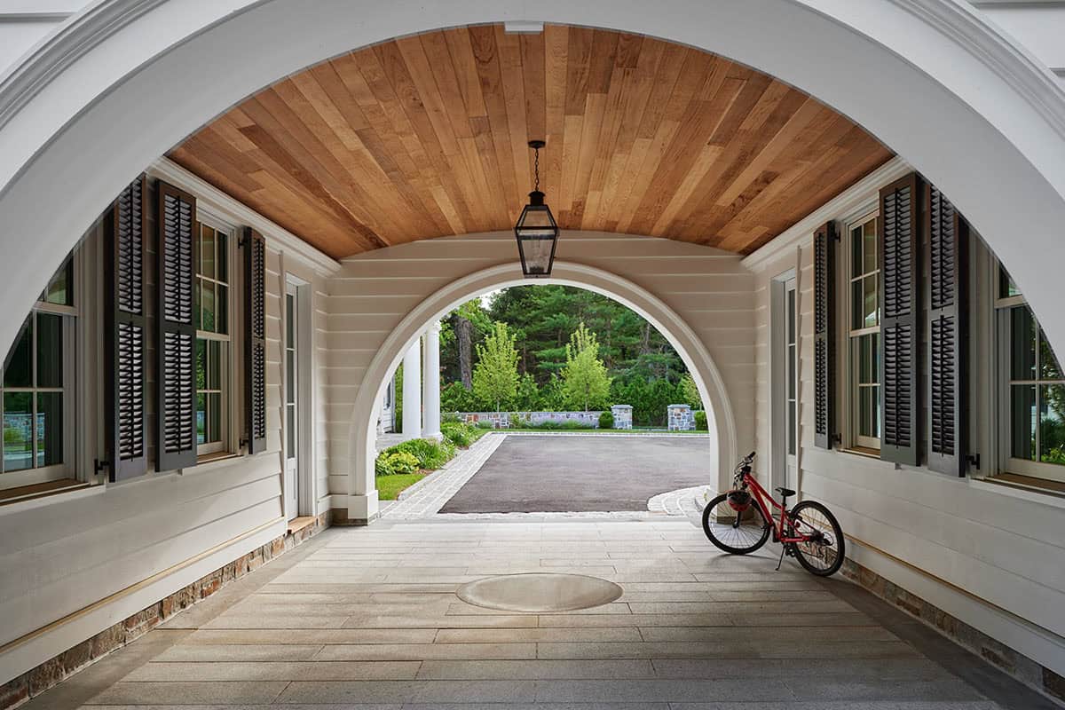 shingle-style colonial home exterior with a porte cochere
