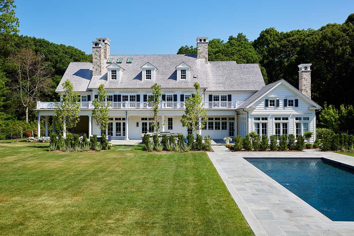 shingle-style colonial home exterior with a pool