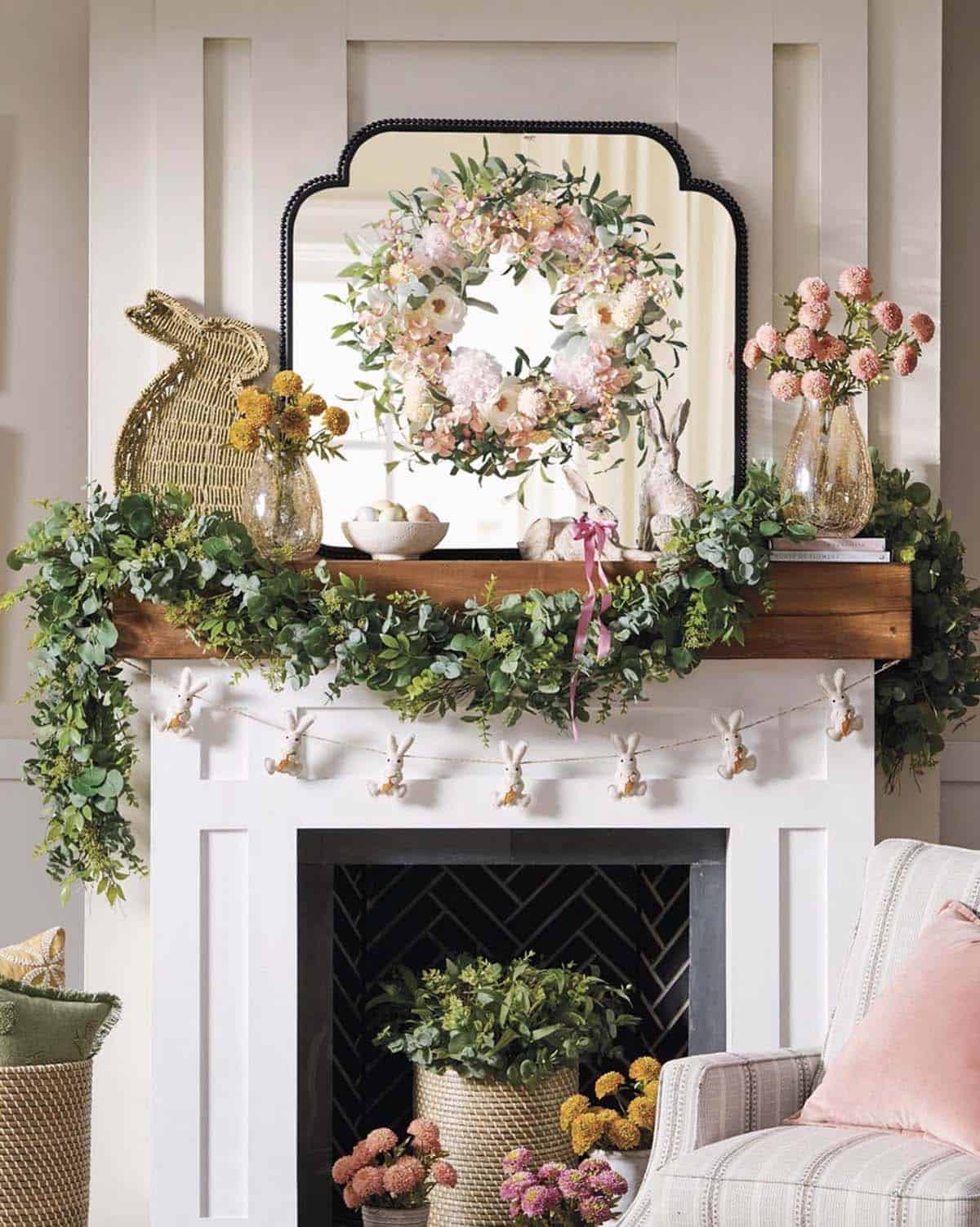 Spring fireplace mantel decorating with eucalyptus garland, floral wreath, bunny figurines, and mums