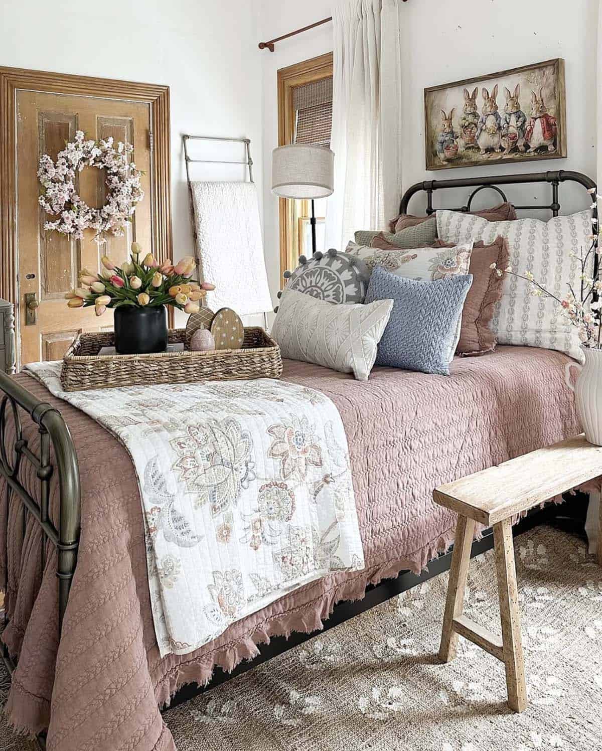 spring bedroom with an iron bed and dusty rose quilt