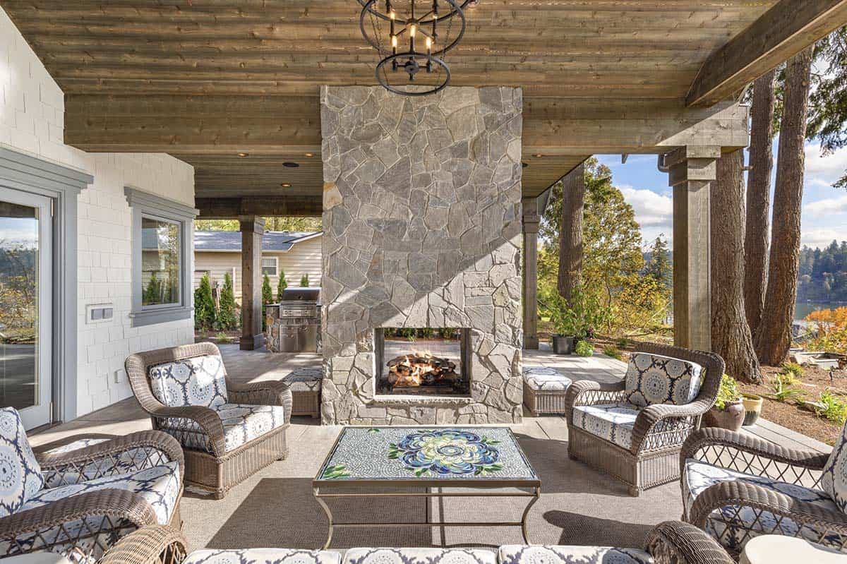 Transitional Covered Patio with a fireplace and outdoor furniture