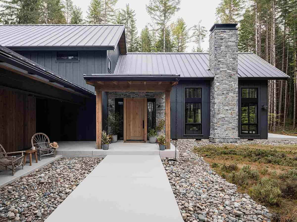 Front entry of alpine cabin with wood beam portico, natural stone facade, and solid oak door, Mt. Rainier, Washington