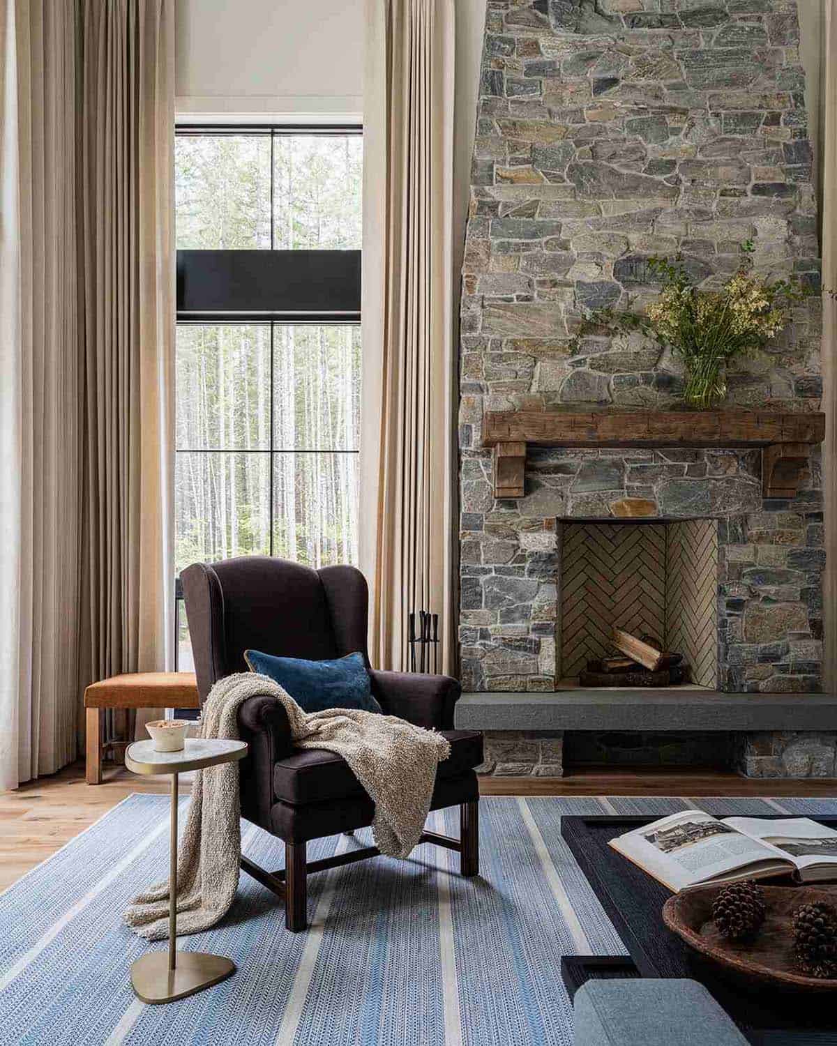 Stone fireplace detail with reclaimed wood mantle, herringbone tile firebox, and leather bench, alpine cabin near Mt. Rainier