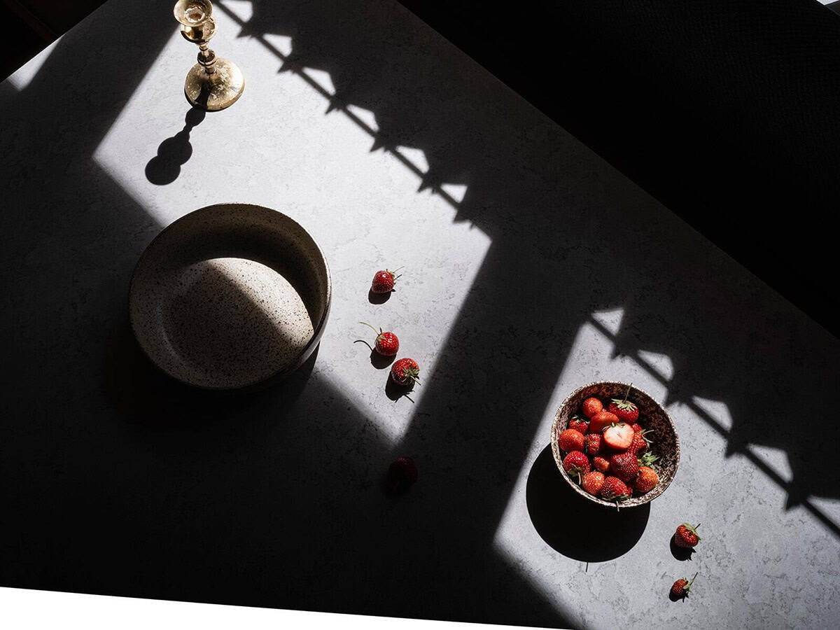 Overhead detail of kitchen stone countertop with ceramic bowls, and strawberries, Mt. Rainier cabin