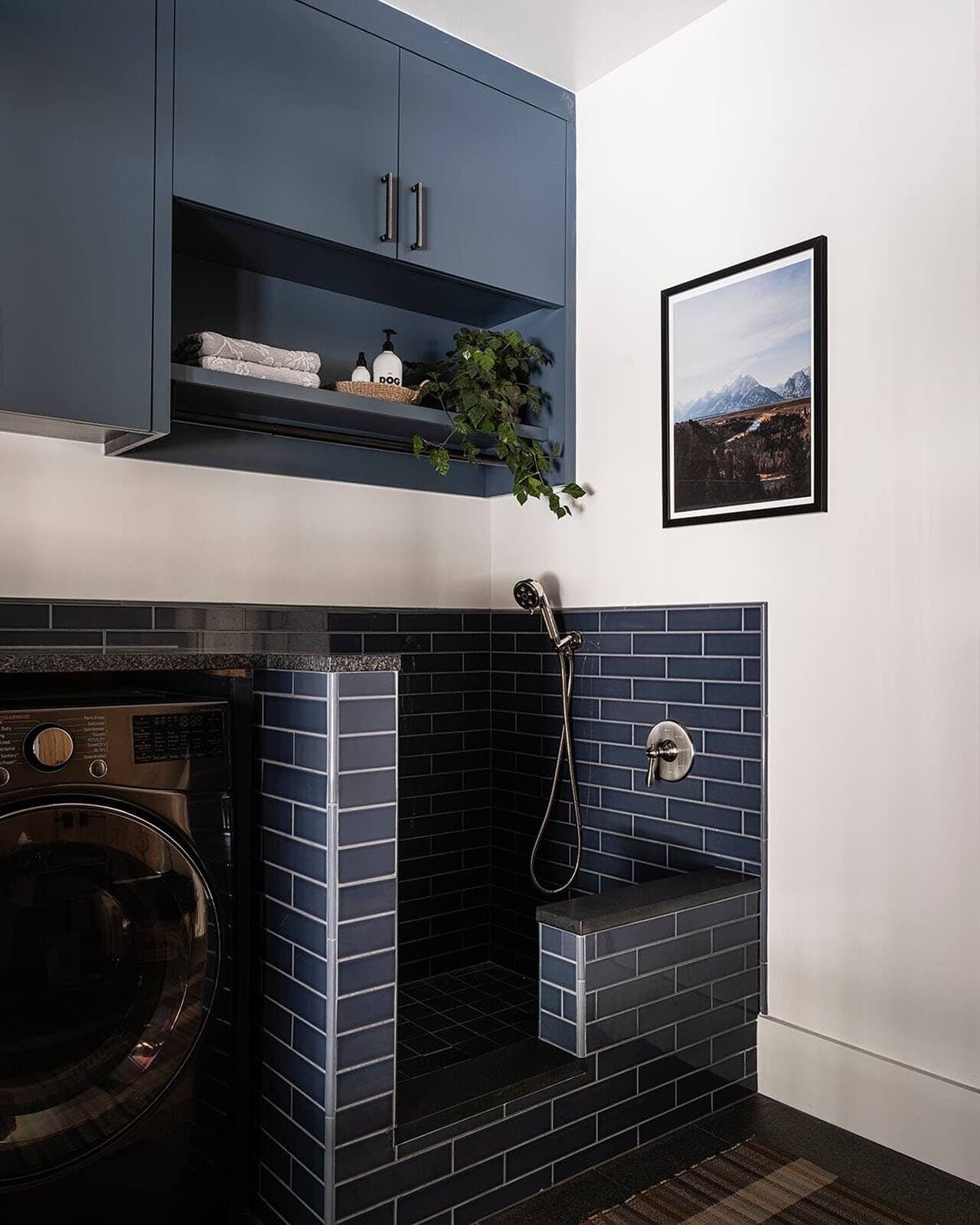 Laundry room with navy cabinetry, built-in dog wash station, and blue subway tile, Greenwater, Washington
