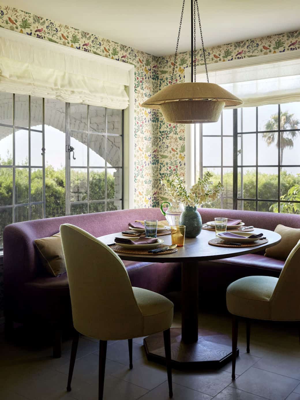 Kitchen breakfast nook with plum curved banquette and botanical wallpaper, Los Feliz colonial revival home