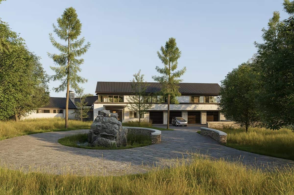 Contemporary home with dark standing seam metal roof and circular stone driveway surrounded by natural meadow landscaping in Hudson Wisconsin
