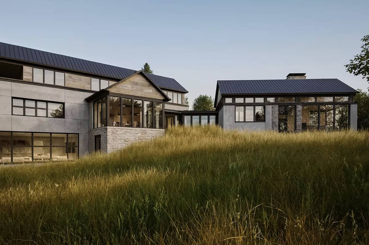 Contemporary home exterior with stone base, black framed windows and natural meadow views in Hudson Wisconsin