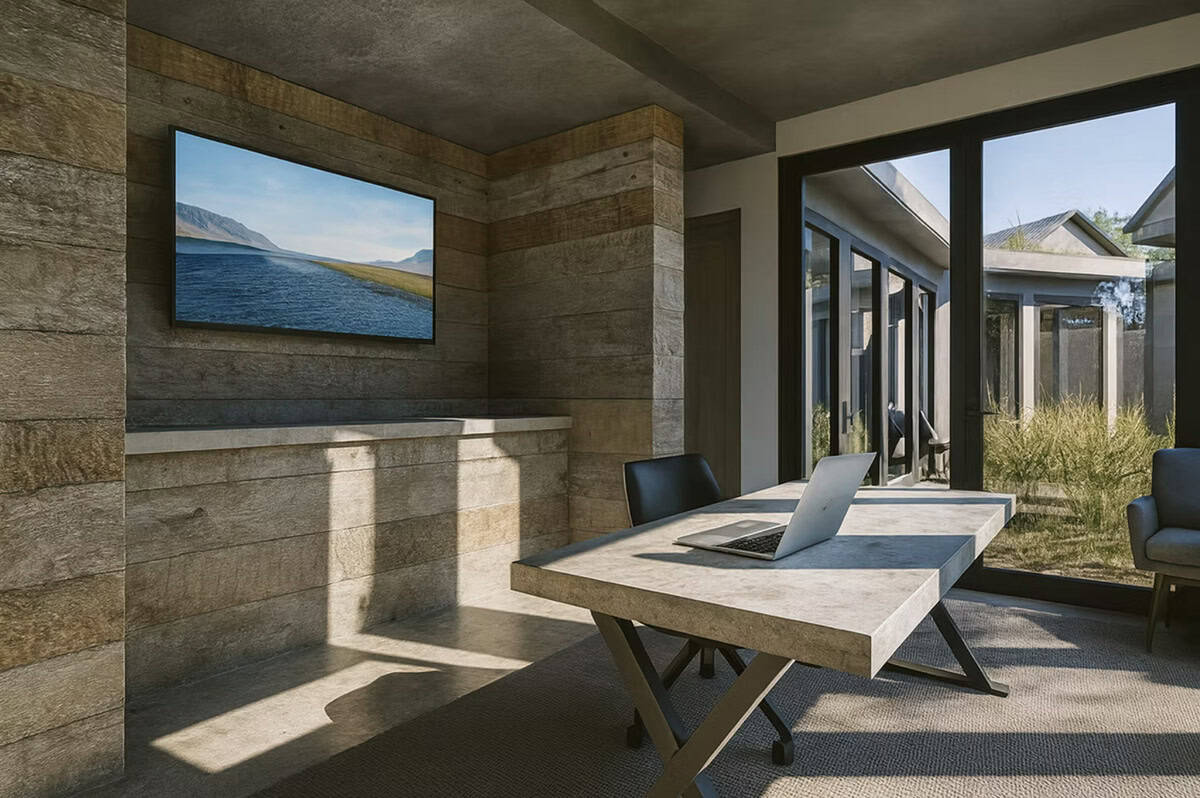 Contemporary home office with reclaimed wood walls, stone desk, and sliding glass doors to outdoor patio in Hudson Wisconsin