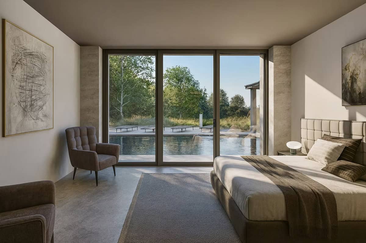 Master bedroom with upholstered headboard, sliding glass doors, and direct pool and meadow views in Hudson Wisconsin contemporary home