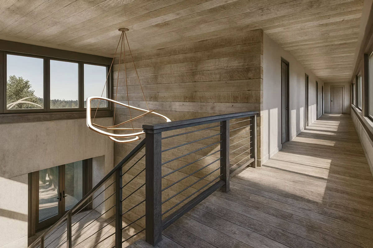 Second floor hallway with wood floors, cable railing, reclaimed wood walls, and sculptural pendant light in Hudson Wisconsin contemporary home
