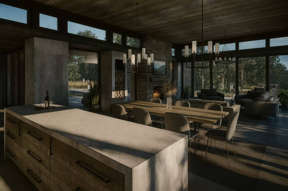 Open plan kitchen island and dining area at dusk with stone fireplace and floor-to-ceiling windows in Hudson Wisconsin contemporary home