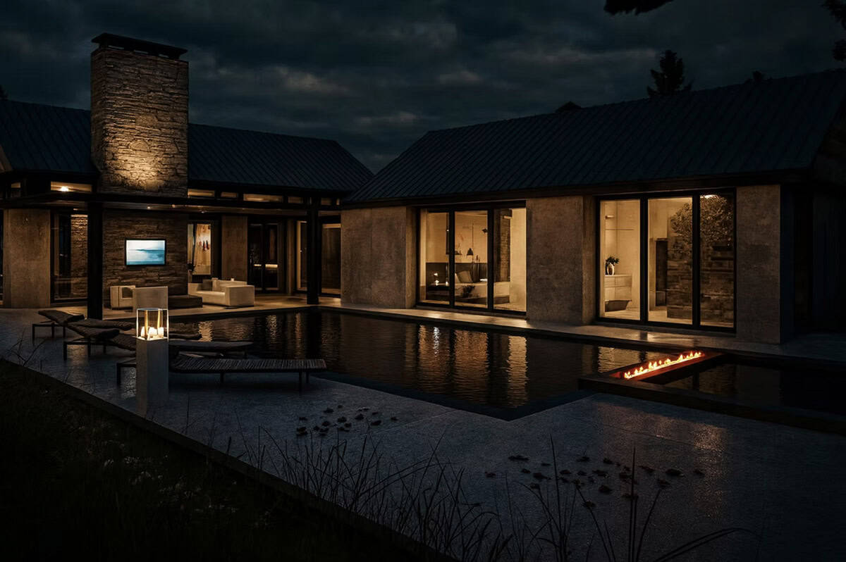 Contemporary home pool and fire feature at night with illuminated interior views and stone chimney in Hudson Wisconsin